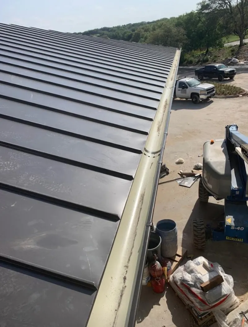 Standing seam panel and gutter detail on a metal roofing jobsite in Rutland